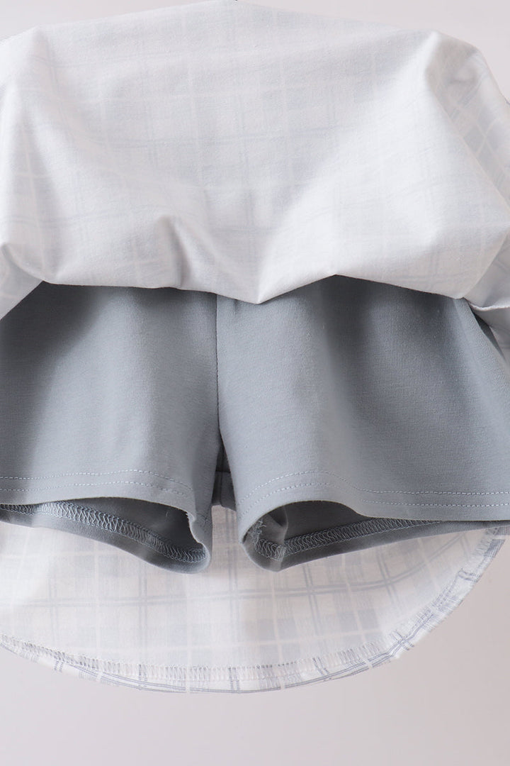 Light plaid ruffle shorts with elastic waistband under white blouse hem