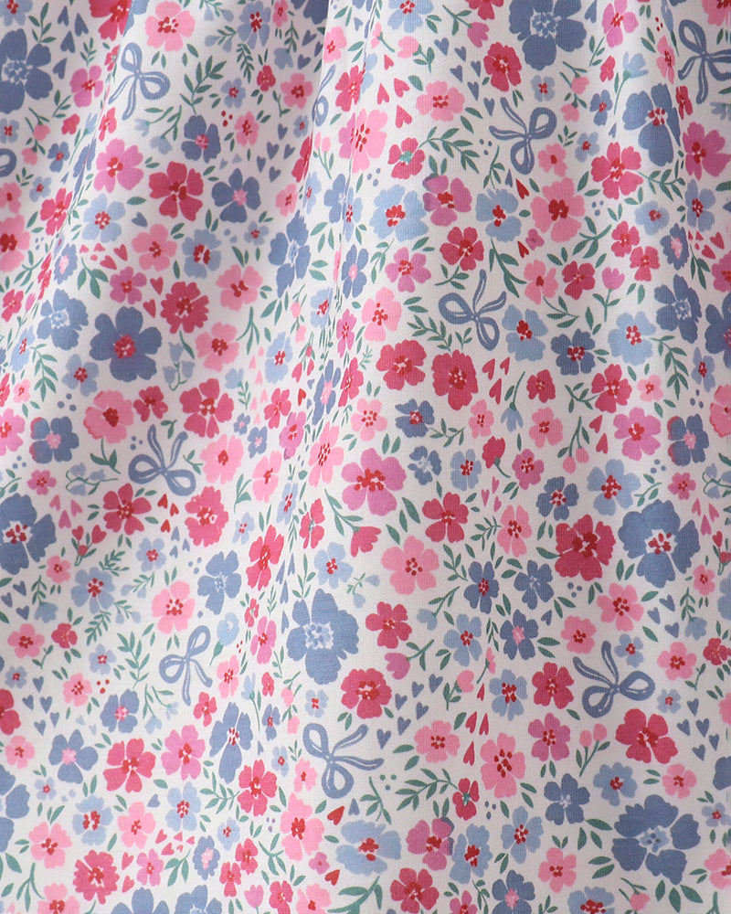 Floral patterned fabric with pink, blue, and green colors on a white background