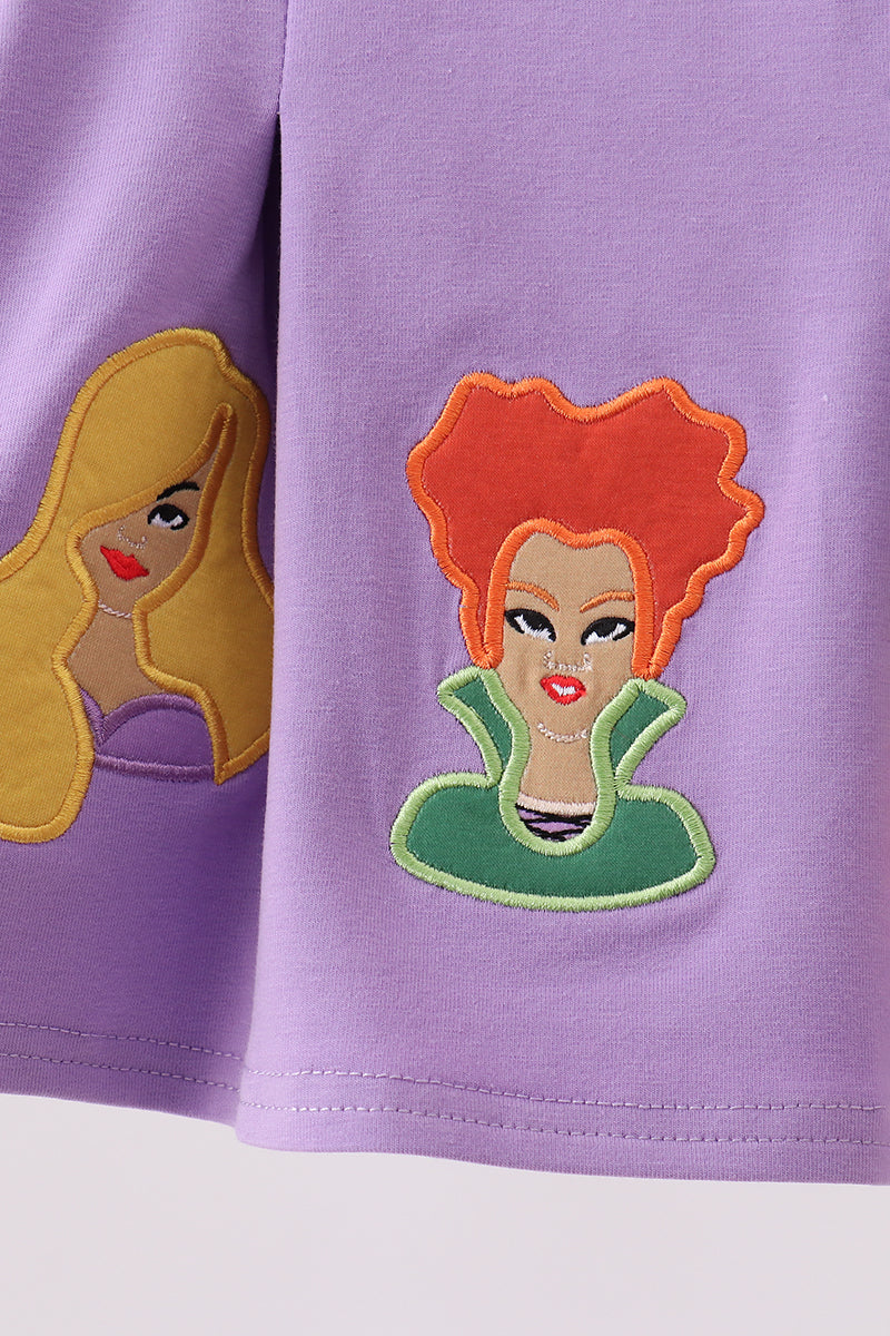Purple shorts with two witch face appliqués