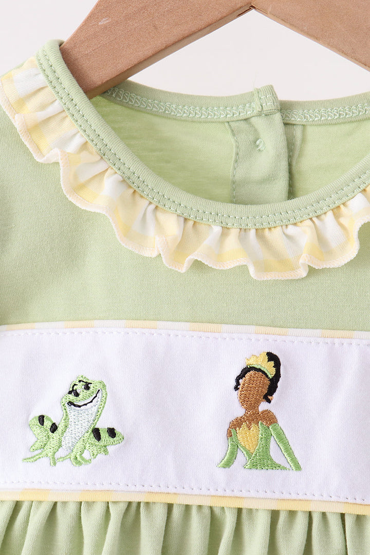 Green dress neckline with scalloped trim and frog embroidery detail