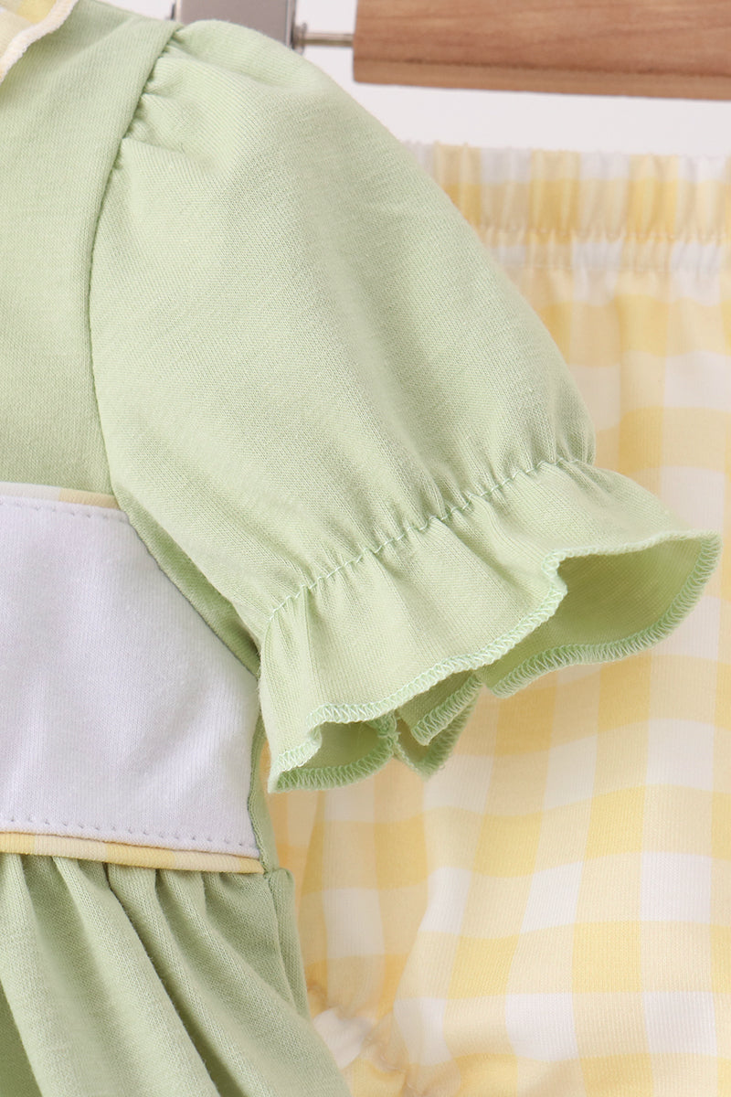 Green dress with puff sleeve and white yoke featuring embroidered frog and girl
