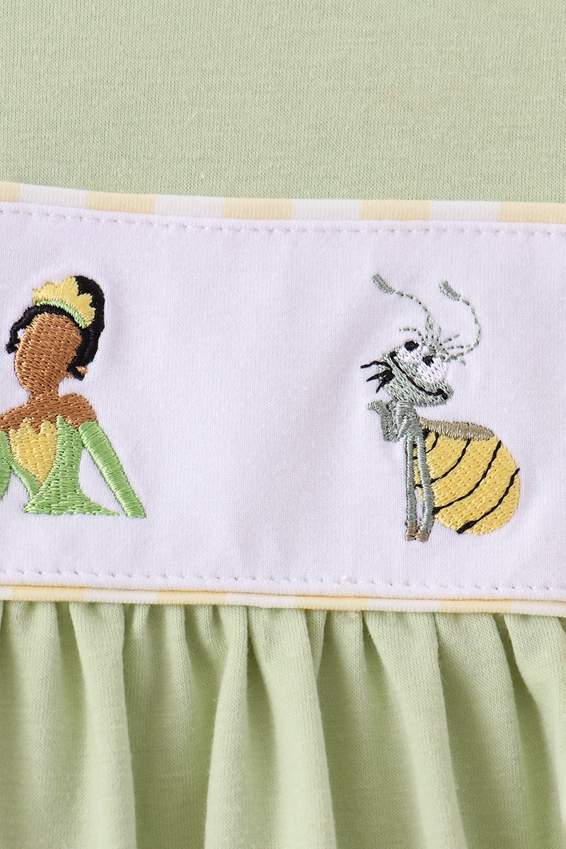White yoke detail with colorful frog and character embroidery
