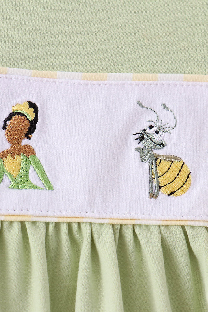 White yoke detail with colorful frog and character embroidery