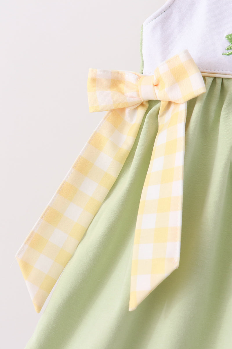 Light green dress with yellow gingham ribbon bow at the waist