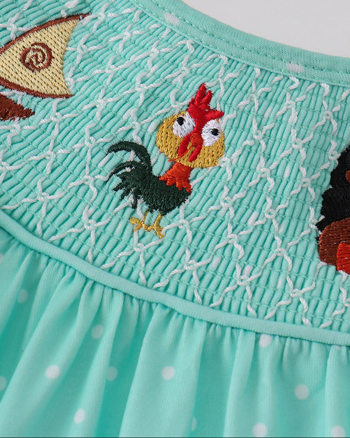 Mint smocked yoke dress with embroidered rooster, bird and owl characters on front