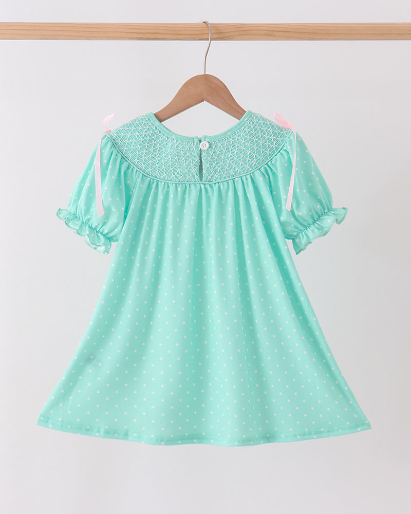 Mint green smocked dress with dotted print, embroidered neck yoke, and flutter sleeves