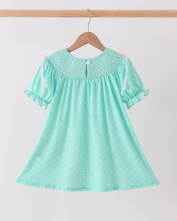 Mint green smocked dress with dotted print, embroidered neck yoke, and flutter sleeves