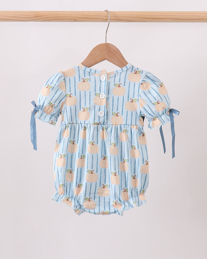 A baby romper in light blue with vertical stripes and a pumpkin print, hanging on a wooden hanger against a plain light background.