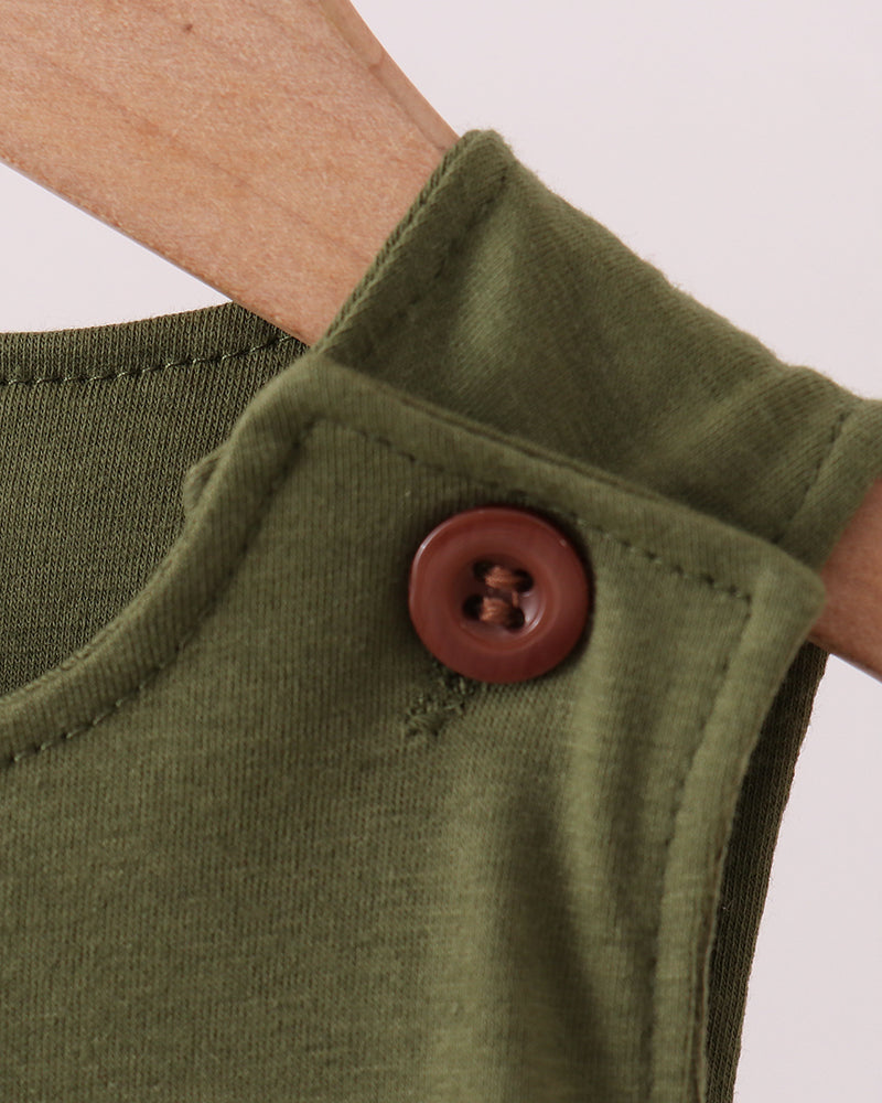 Close-up of a green sleeve with a brown button on a white background