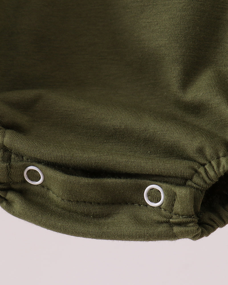 Close-up of green fabric with white buttons on a light gray background