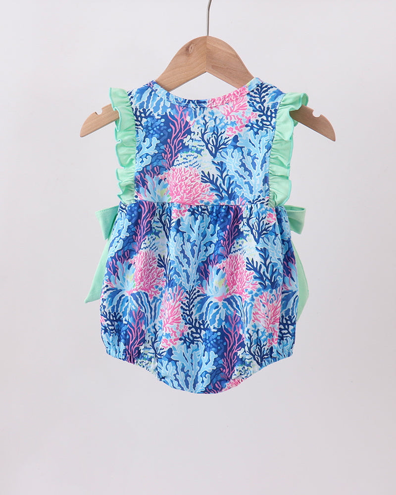 Colorful floral baby romper on a hanger against a white background