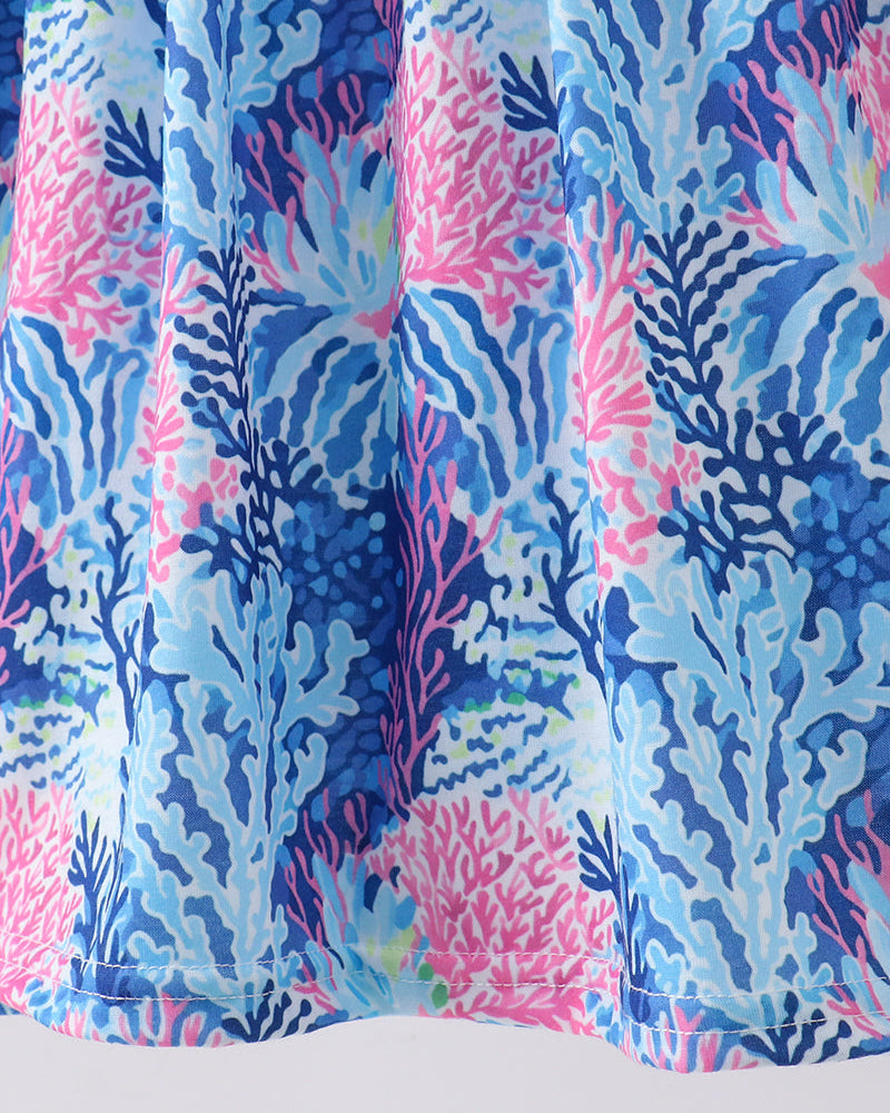 Coral and blue patterned fabric on a white background