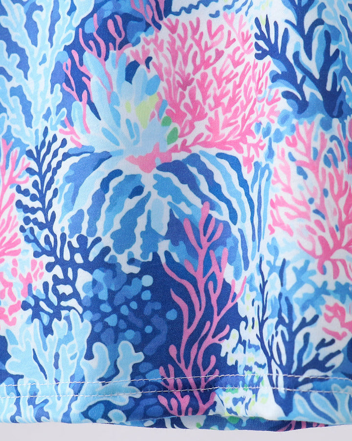 Coral and blue patterned fabric with pink accents on a white background