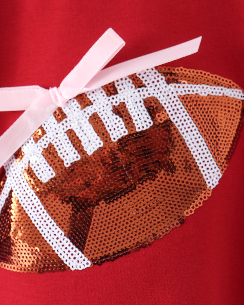 Red romper with football sequin applique and white ribbon bow detail