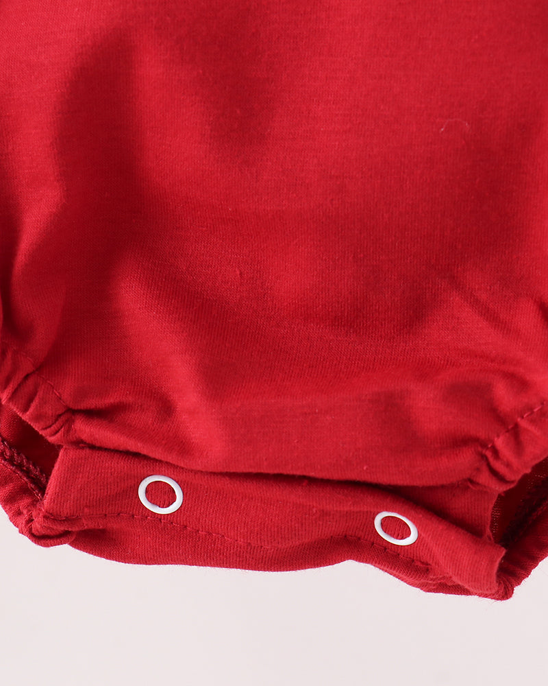 Red bubble romper with snap-button leg opening and gathered ruffle hem