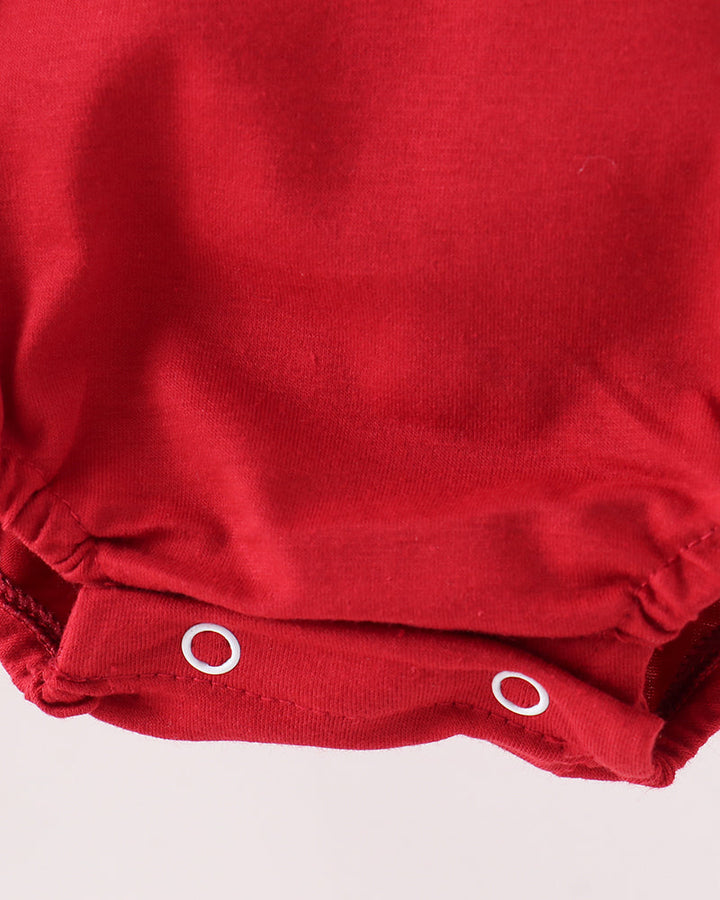 Red bubble romper with snap-button leg opening and gathered ruffle hem