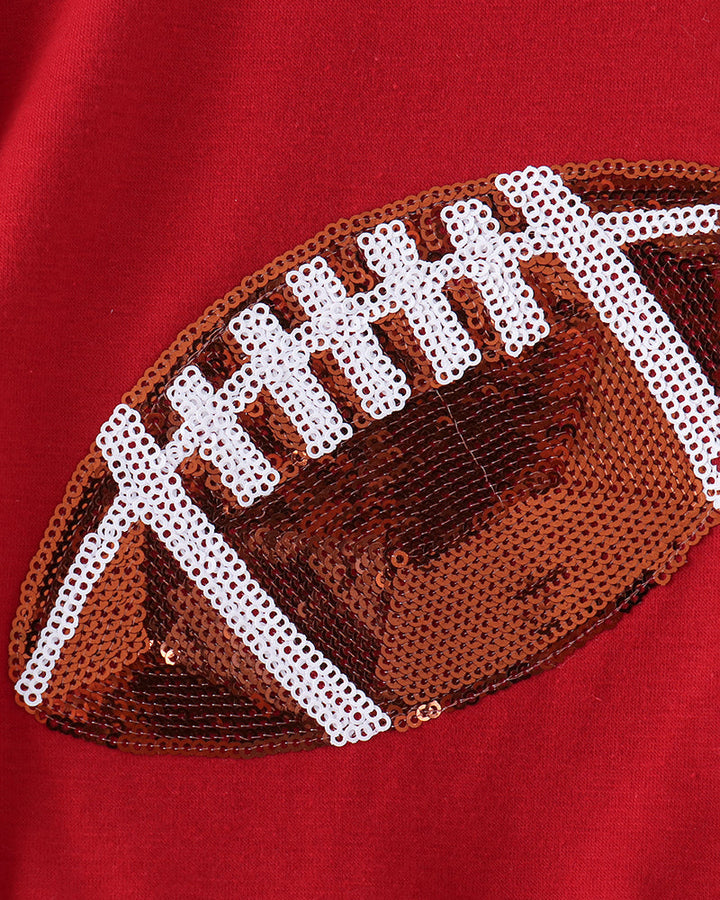 Red top with football sequin applique in white and brown