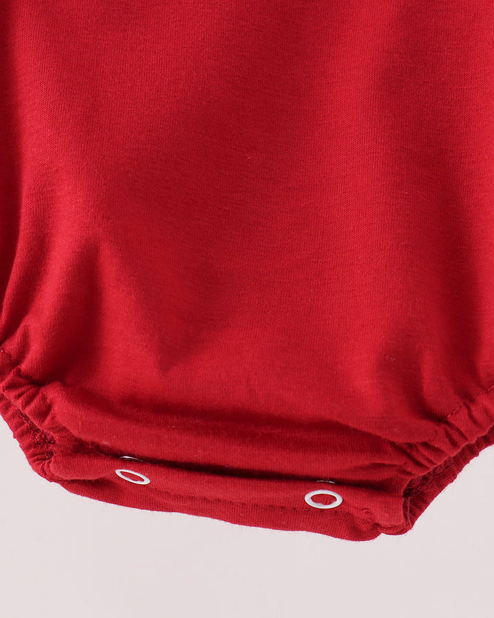 Red bubble romper hem with gathered leg openings and snap closure