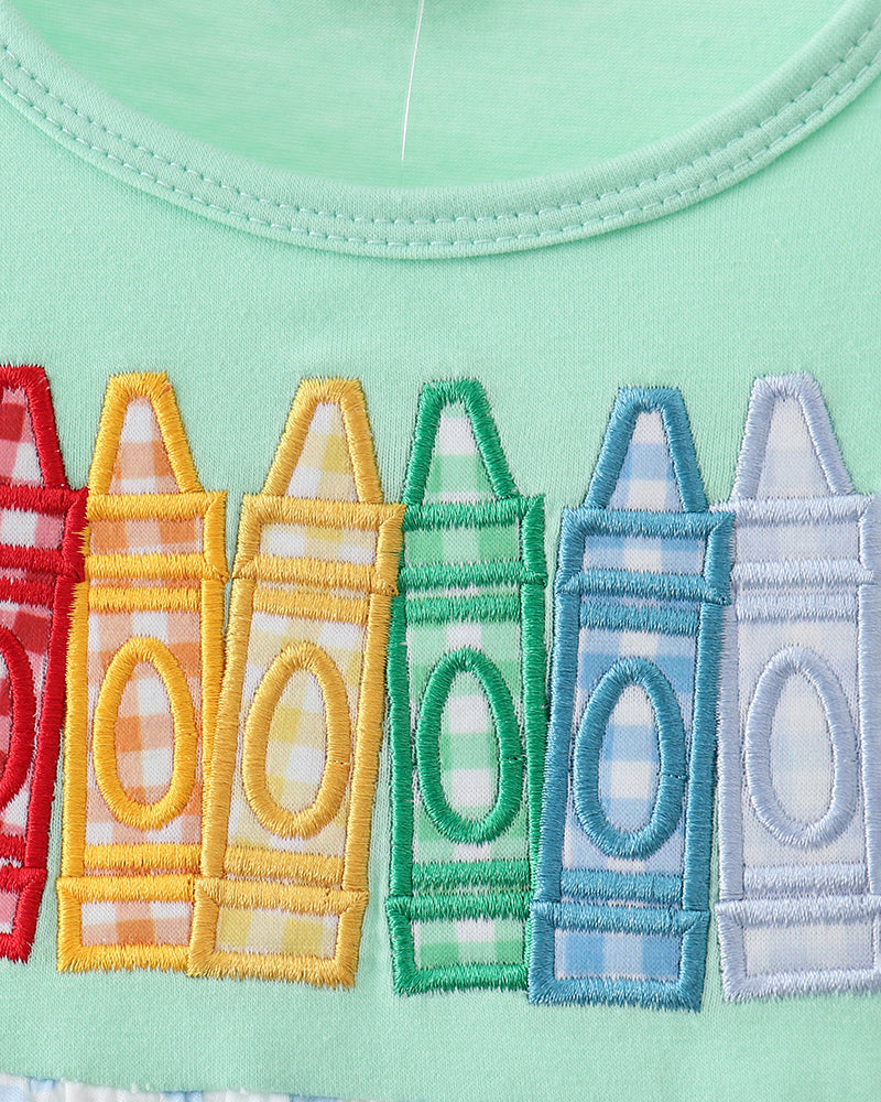 Crayon embroidery on green dress