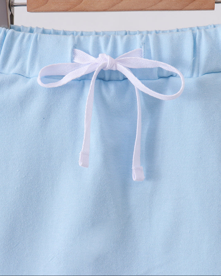 Light blue skort with scallop hem and drawstring bow at waist