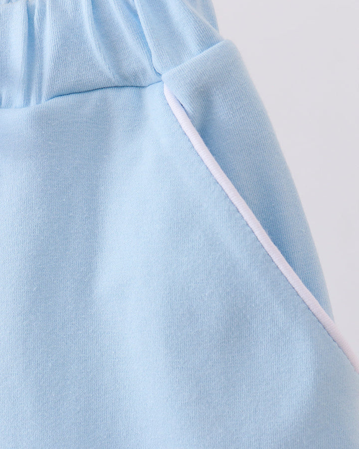 Light blue skort close-up with angled side seam and drawstring tie