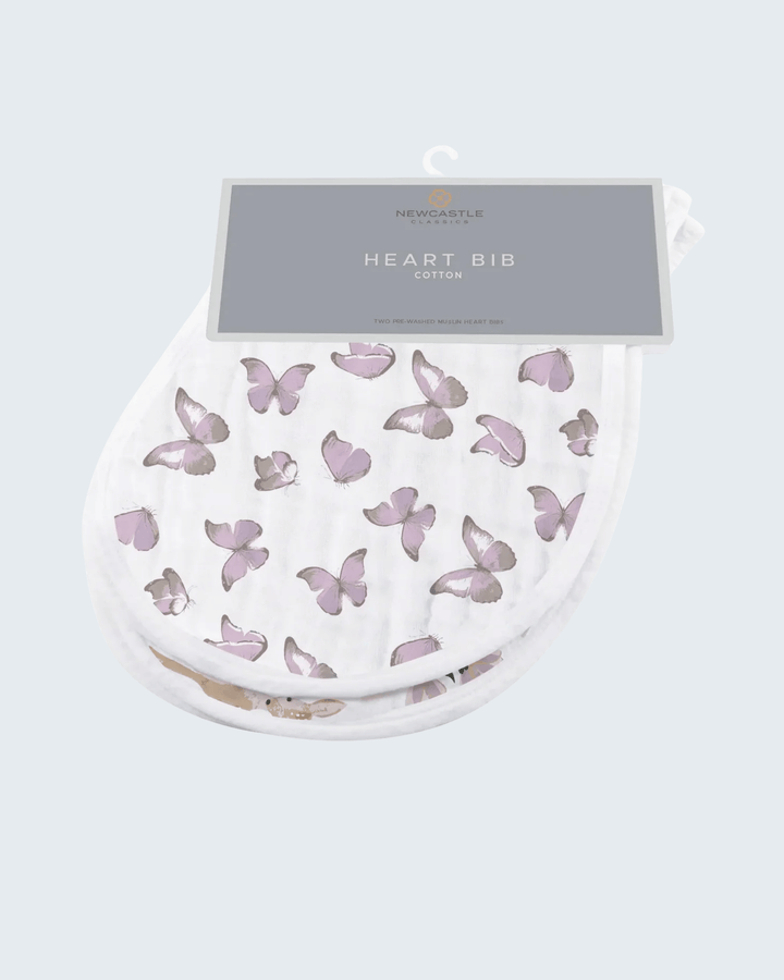 Heart-shaped bib with butterfly pattern in packaging on a light gray background
