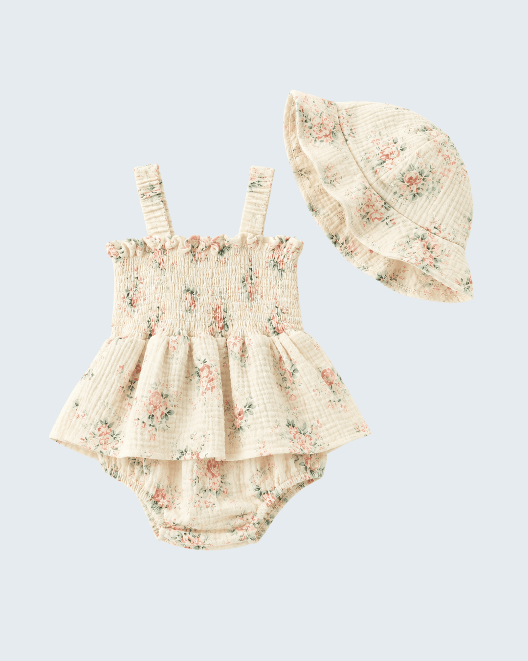 Floral baby romper with matching hat on a light gray background