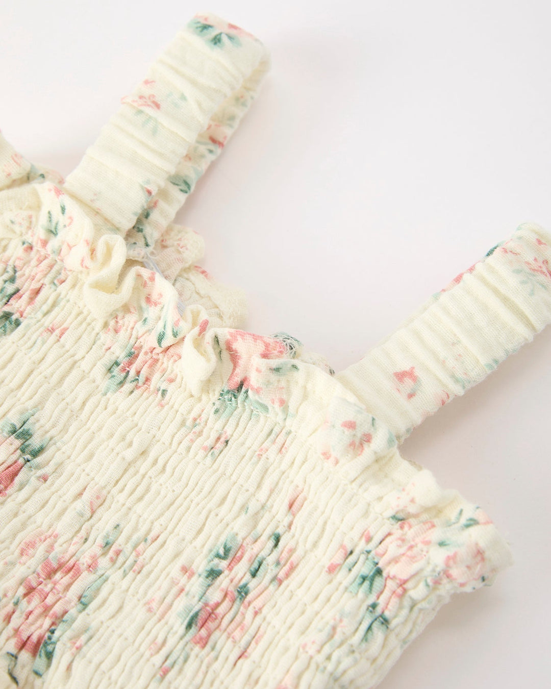 Floral patterned baby outfit on a white background