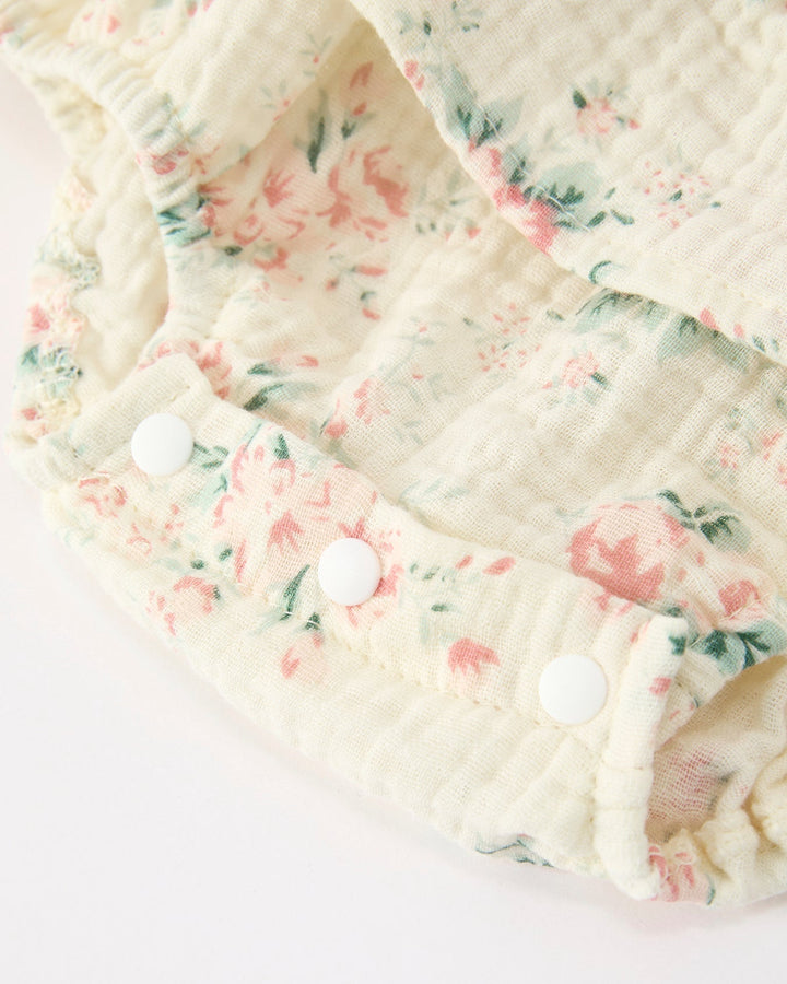 Floral-patterned fabric with white buttons on a light background