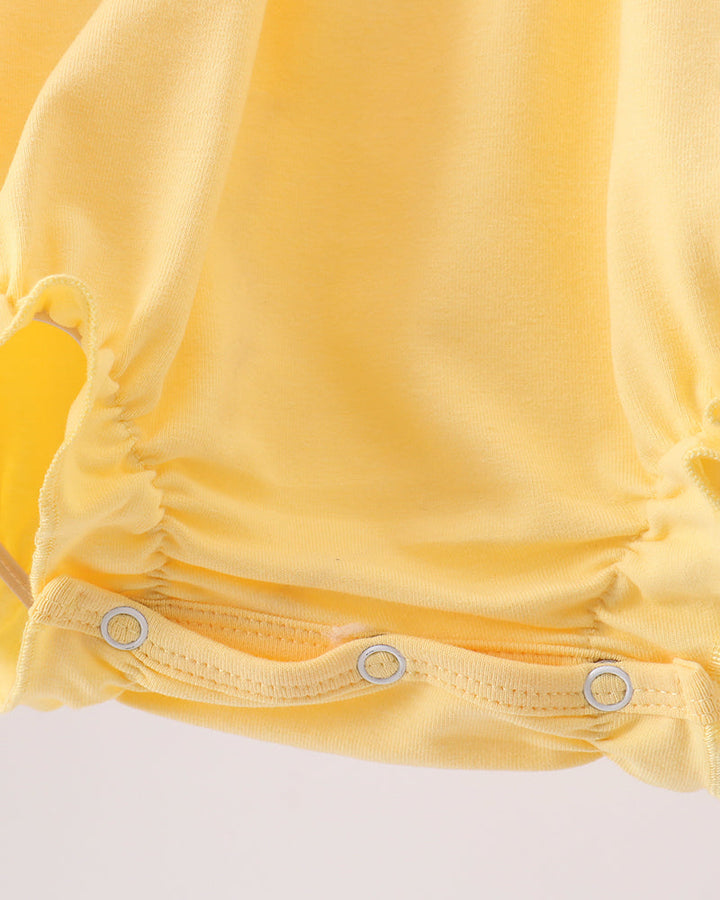 Yellow baby romper with snap closure