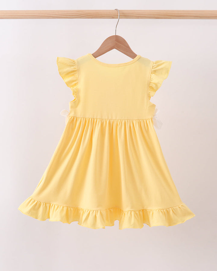 Mustard Character Embroidered Ruffle Dress on wooden hanger