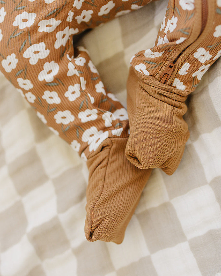 Brown floral-patterned socks on a checkered fabric background