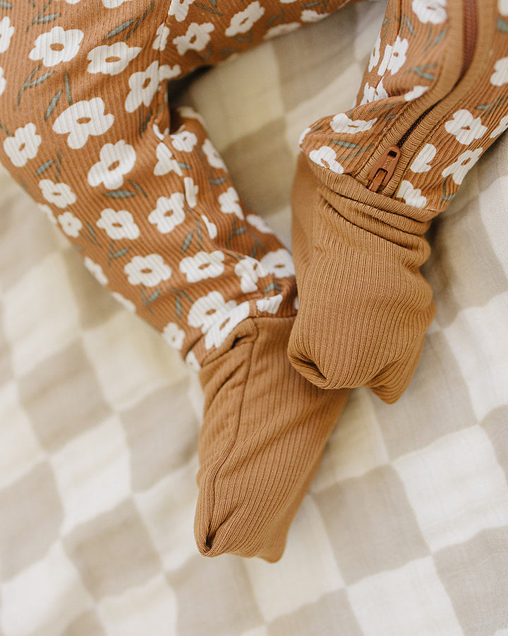 Brown floral-patterned socks on a checkered fabric background