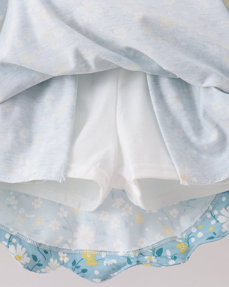 Close-up of a white fabric with blue floral patterns on a light gray background