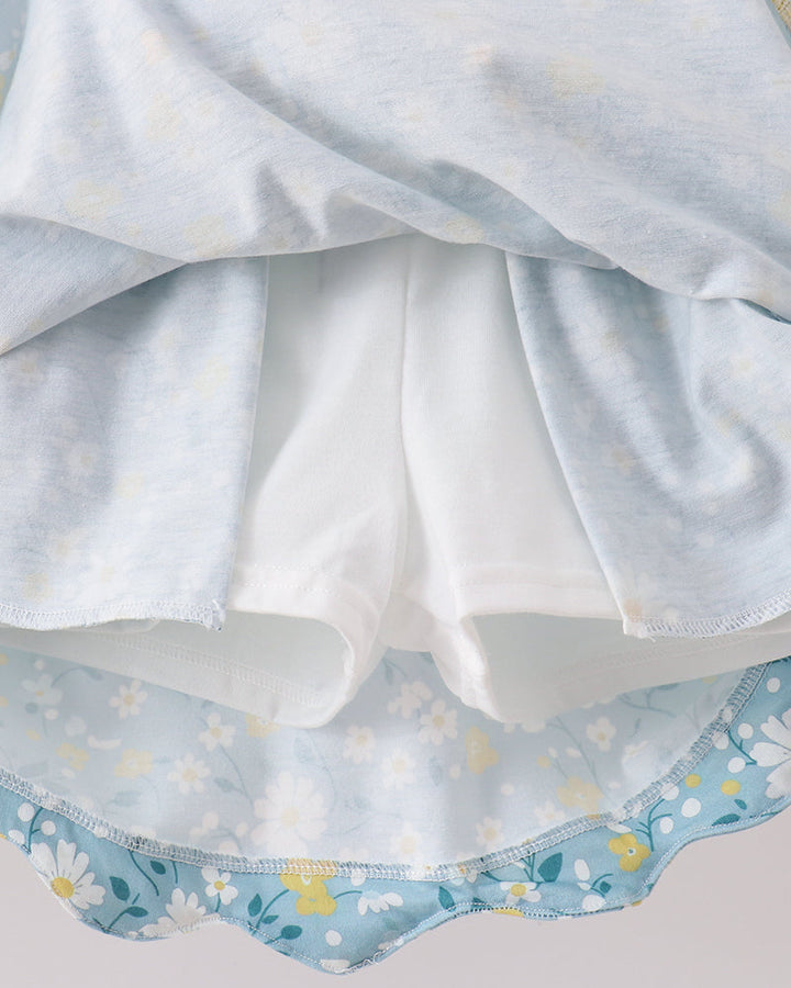 Close-up of a white fabric with blue floral patterns on a light gray background