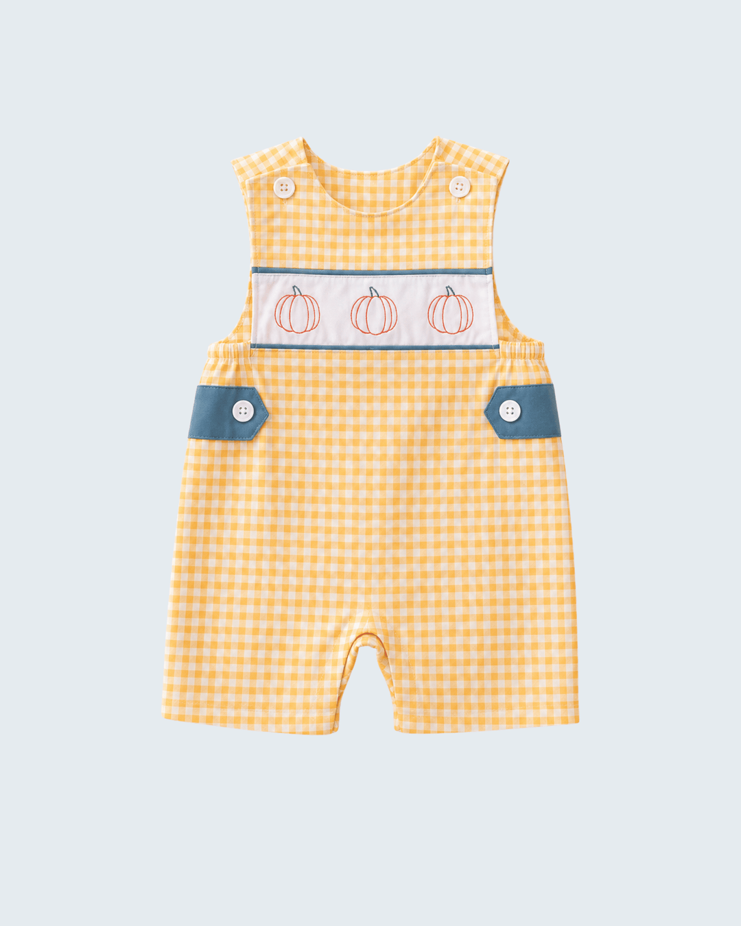 A baby romper in a yellow and white gingham pattern, featuring a decorative chest panel with three embroidered orange pumpkins, blue buttoned flap pockets, and snap closures at the shoulder.
