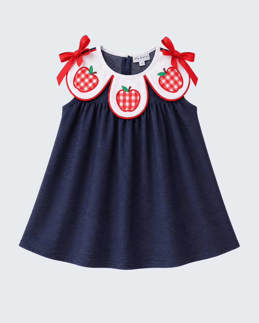 Navy denim dress with red apple applique collar and tied red bows
