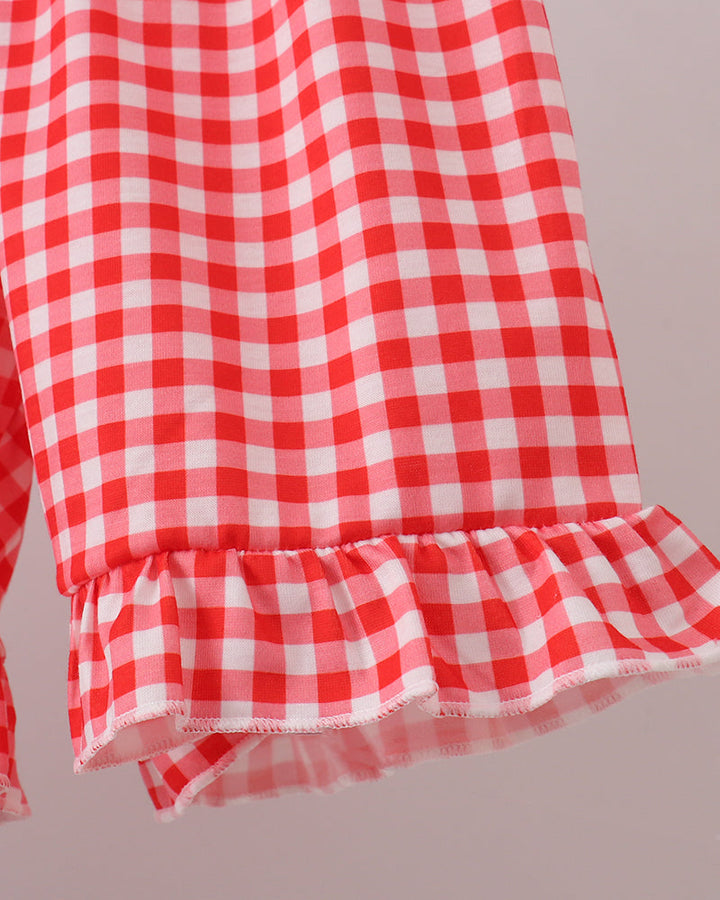 Red-and-white gingham shorts with ruffled hem and layered mesh-like trim