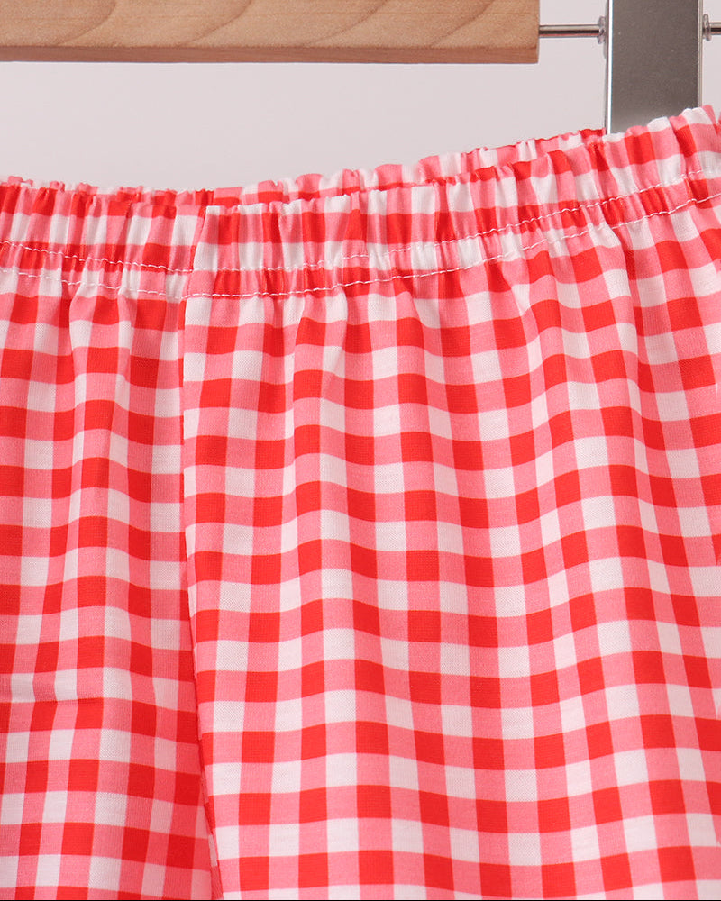 Red-and-white gingham shorts with elastic waistband and gathered ruffle