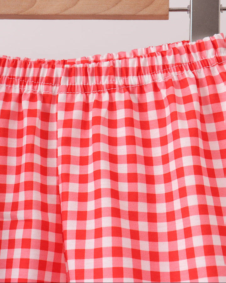 Red-and-white gingham shorts with elastic waistband and gathered ruffle