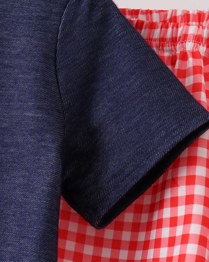 Navy denim sleeve next to red gingham elastic-waist shorts