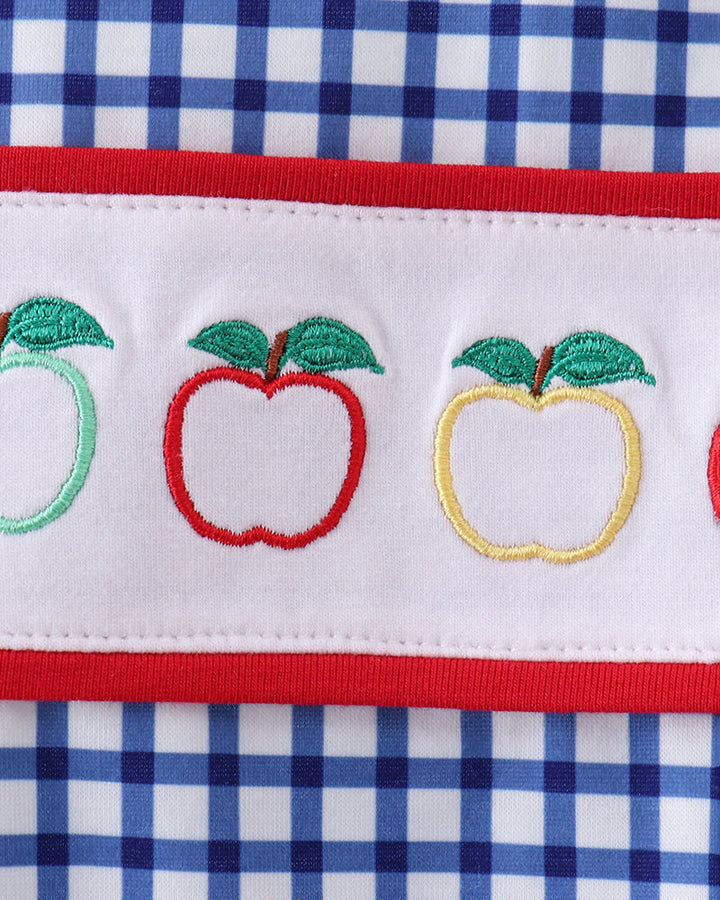 Blue gingham fabric with embroidered apples