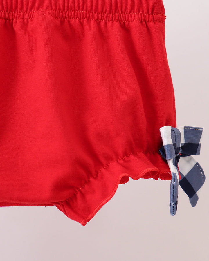Red toddler bloomer shorts with smocked waistband and navy bow ties