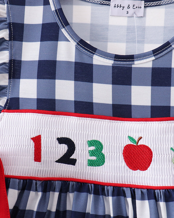 Navy gingham dress neckline with smocked band showing 123 and apple embroidery