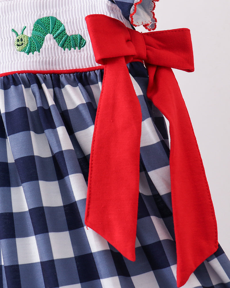 Navy and white gingham dress with red bow and green apple embroidery on smocked panel