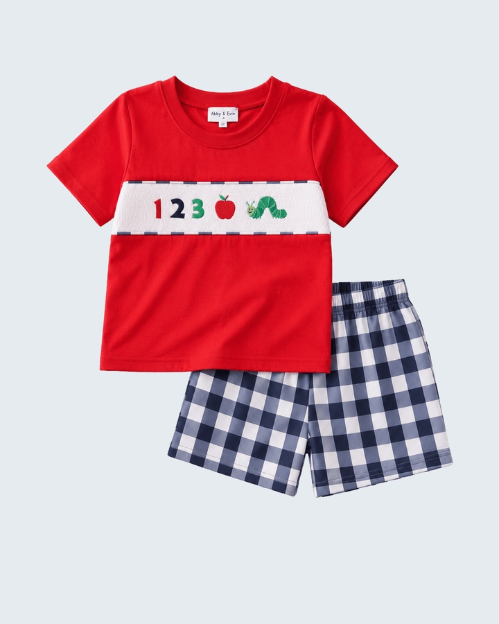 Kids red graphic tee with apples and 123, paired with navy check shorts