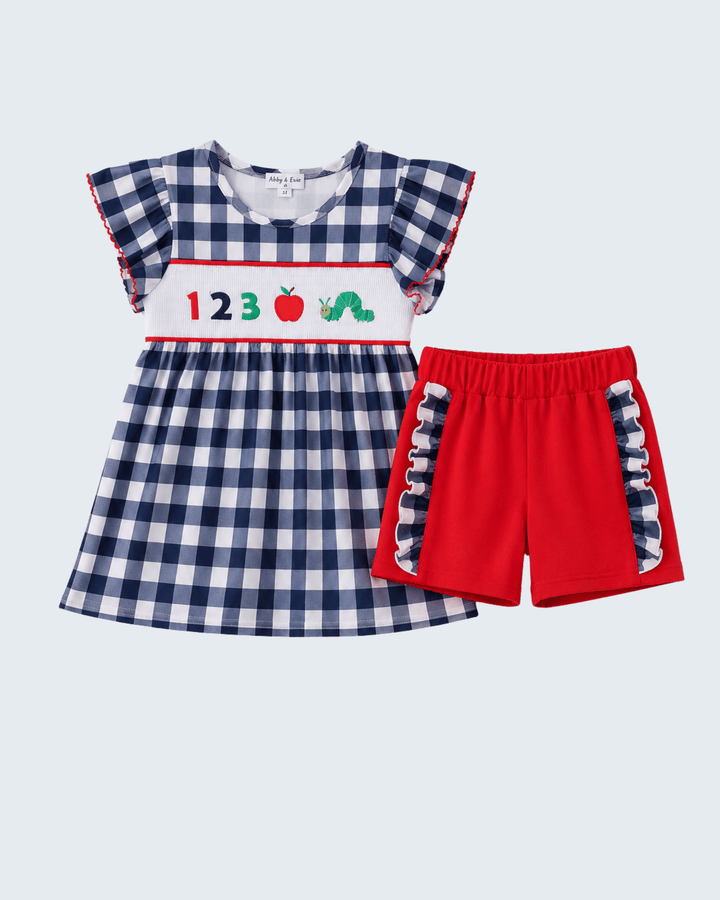 Navy gingham ruffle dress set with red shorts and embroidered apple details