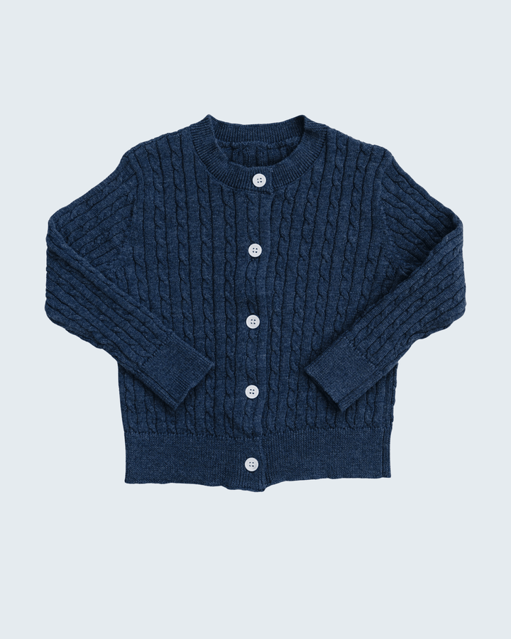 A dark navy blue cable-knit cardigan sweater with a button-up front, laid flat against a light gray background.