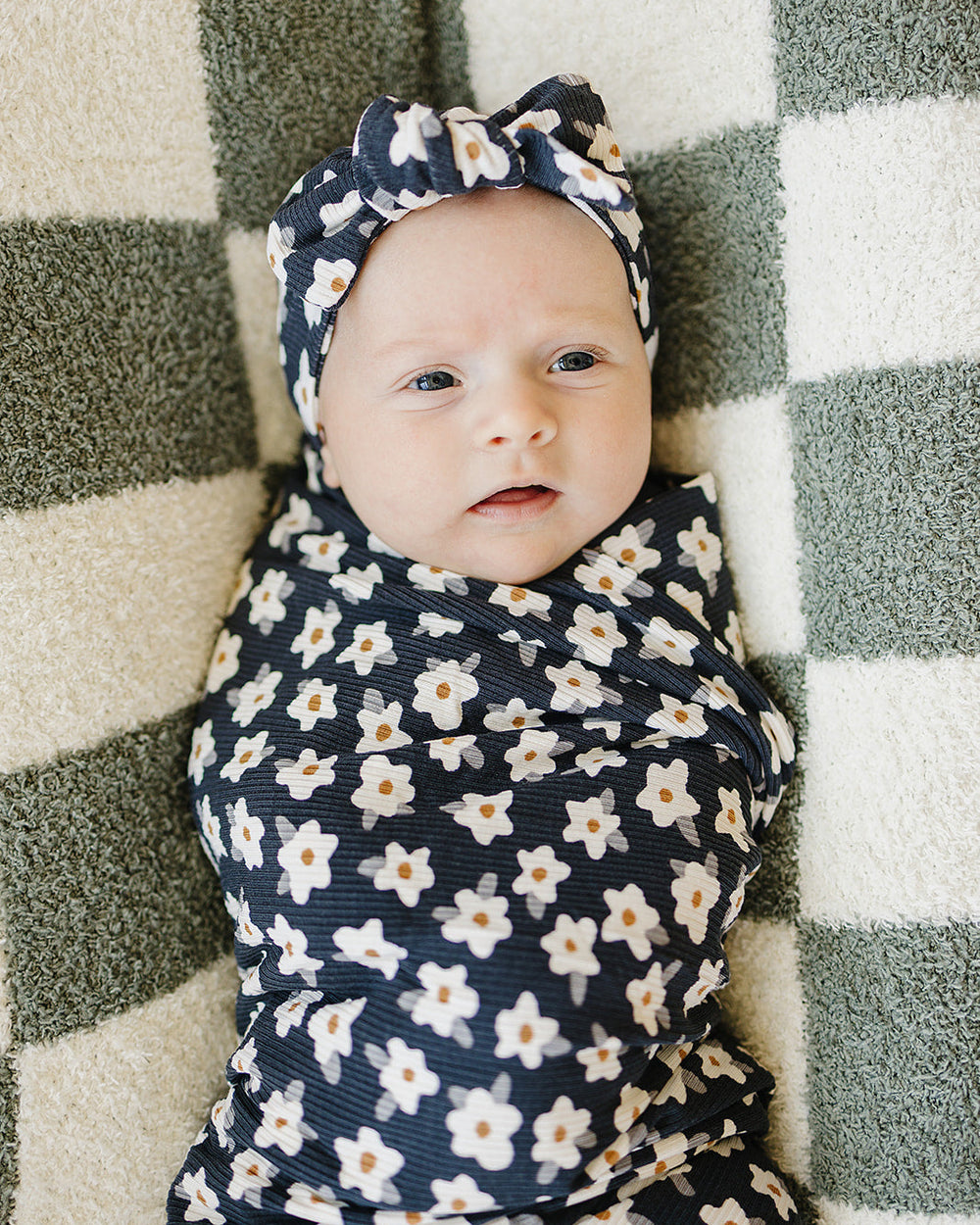 Navy daisy head wrap with wide knotted band on baby's portrait