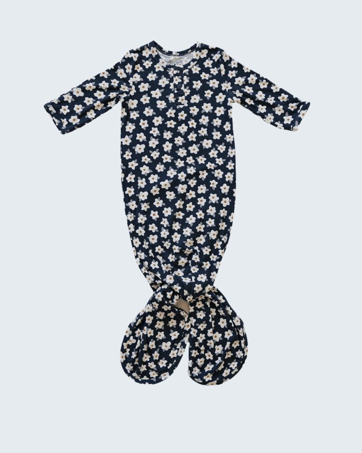 Navy floral baby gown on a light blue background